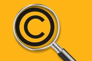 Copyright symbol and magnifying glass.
