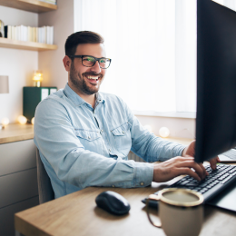 Photo of an individual sitting at a desk typing.