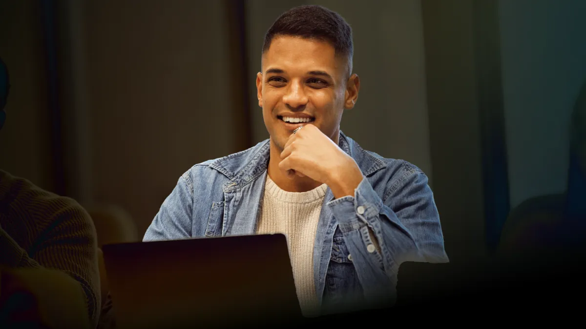 A man sitting at a laptop, learning something