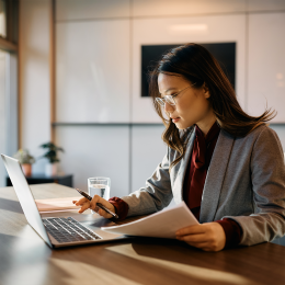 Photo of an individual sitting at a desk working on a laptop